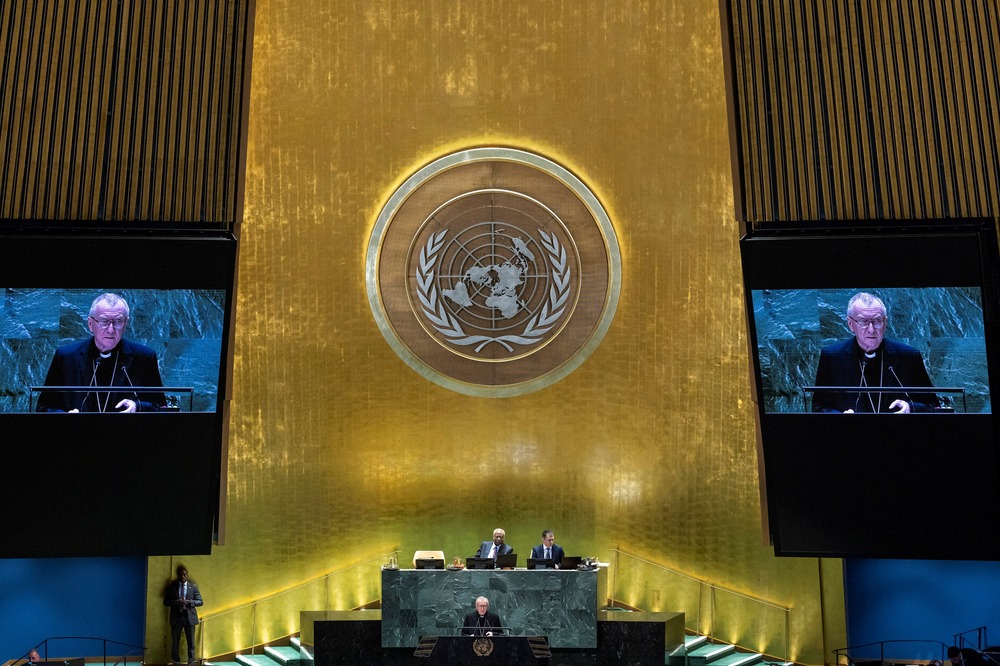Vatican Secretary of State, Cardinal Parolin, United Nations General Assembly, New York, Sept. 28, 2024. Large United Nations emblem and projector screens showing Parolin speaking.